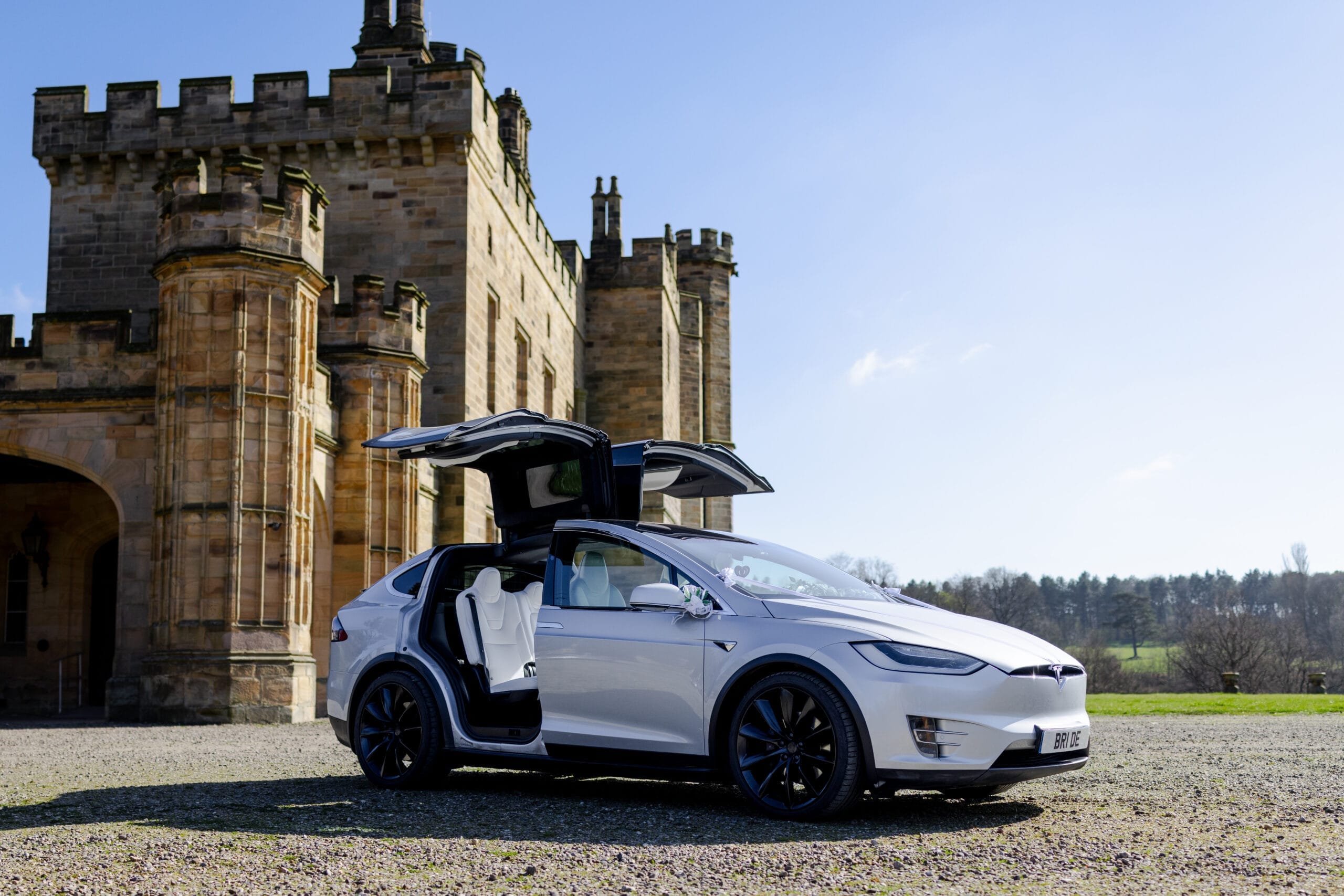 Tesla electric wedding car parked outside Beamish Hall – a stylish and sustainable transport option for modern weddings.